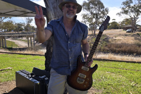 Stuart Matheson poses with his guitar after his performance. Photo: Emilee Jones-Pritchard