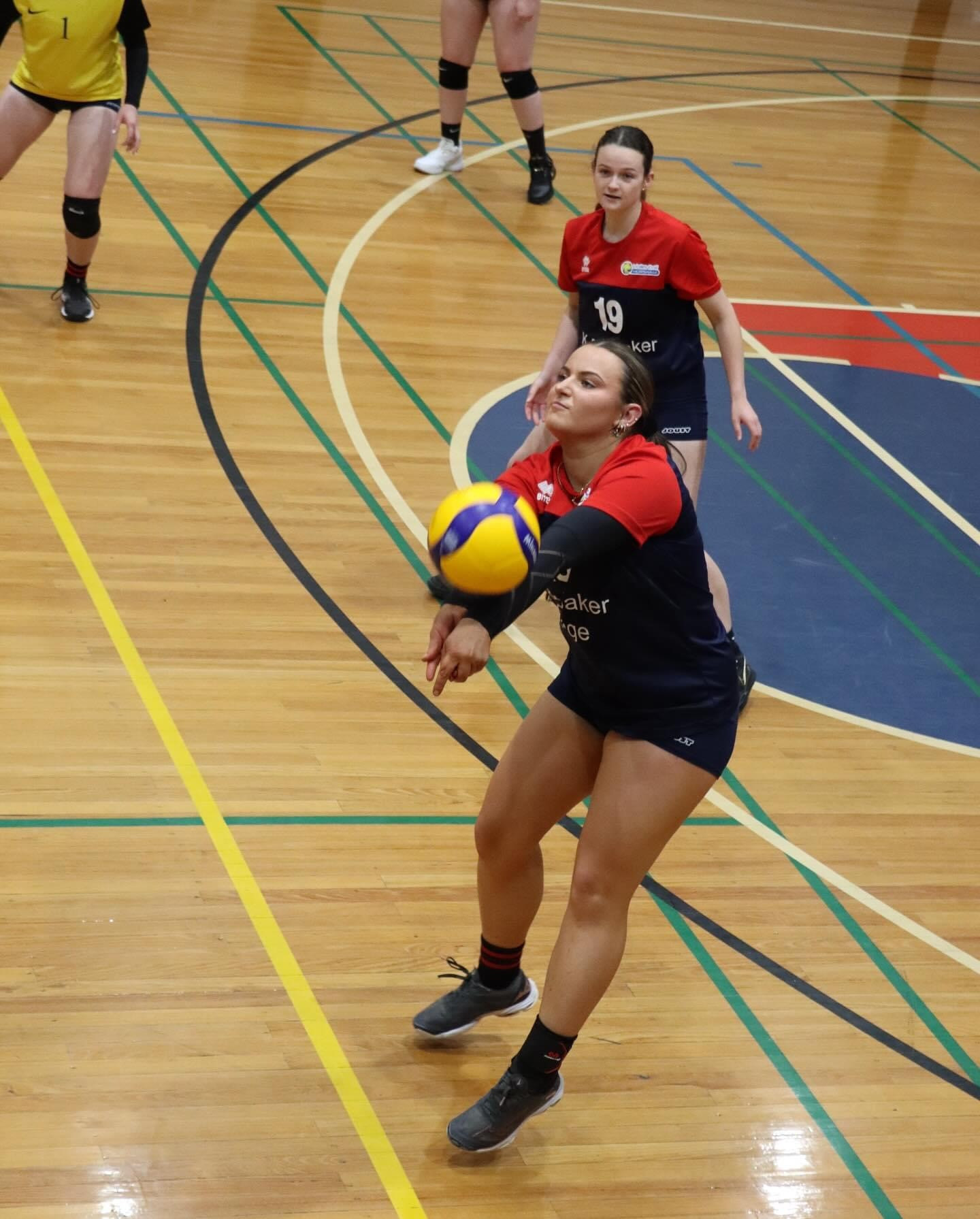 Cleo Baker passing off serve as teammate Emily Hannan watches on.