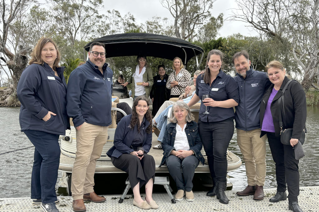 Grampians Wimmera Mallee (GWM) Tourism staffers (from left) Grampians partnership manager Kerrie Mulholland, Wimmera Mallee partnerships manager Ian Gumela, marketing manager Georgia Bennett, administrator Caron Fraser, projects coordinator Tessa Llewellyn and CEO Marc Sleeman with Helen Hobbs from Kaniva in front of As Times Goes By.