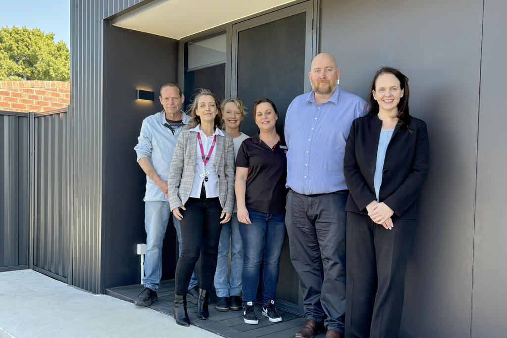 (From back) Salvation Army homelessness case managers John Murgatroyd and Jaimie Clarkson, Uniting Wimmera Homelessness Martene Blay, Salvation Army Homelessness team member Renae, Haven Home Safe head of housing Matt O'Connor and Haven Home Safe chief operations officer Vanessa Brotto in front of one of the new units in Horsham.