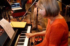 Andrea Phelan concentrates as she plays the piano with her bandmates.