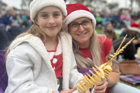 Lisa and Ella Warrick, 8 enjoy the entertainment at last year’s Carols by Candlelight.