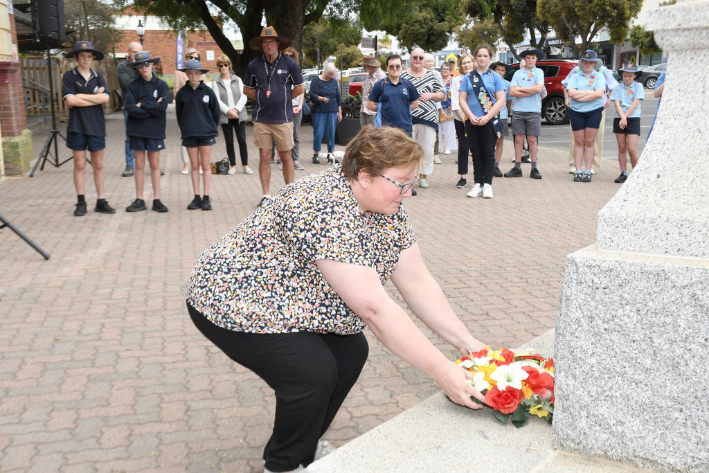 Cr Karly Kirk, representing the Yarriambiack Shire, lays a wreath, while Cubs, Scouts and various school representatives stand to attention while they wait their turn to lay their wreaths on Remembrance Day on Monday.