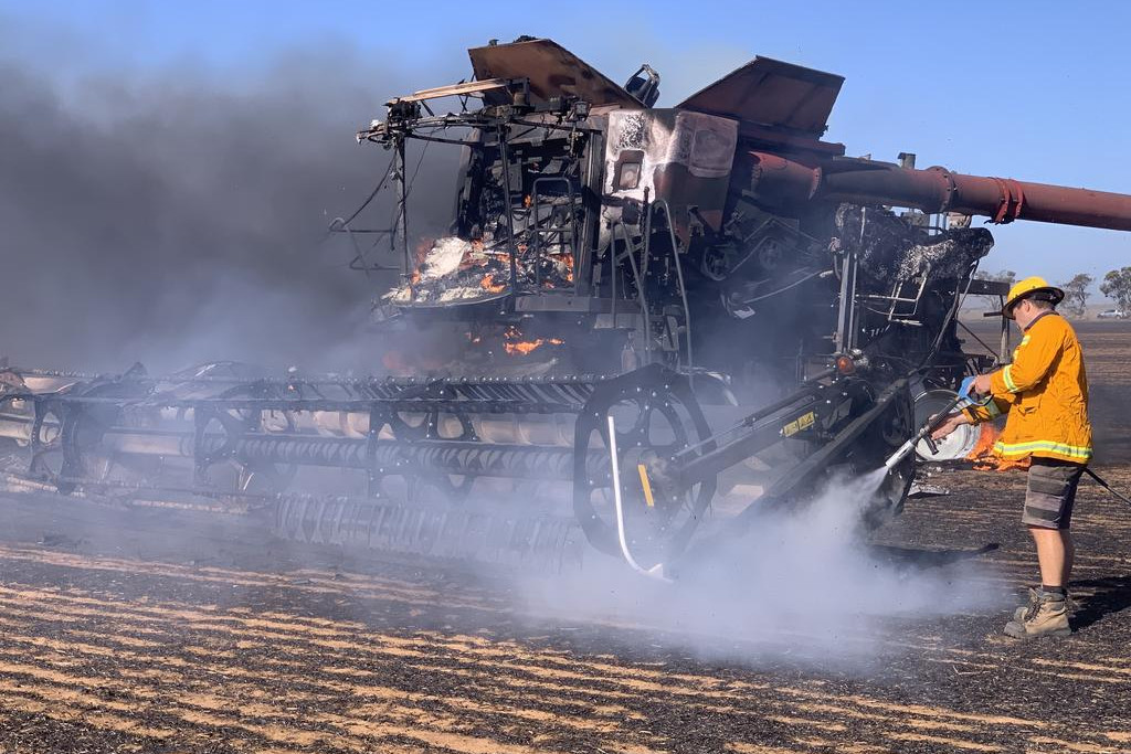 A CFA crew member is trying to contain a fire at Peter Quick's farm in Brim.