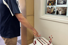 Dimboola and District Financial Services board chairperson Nick Pietsch cutting the celebratory cake.