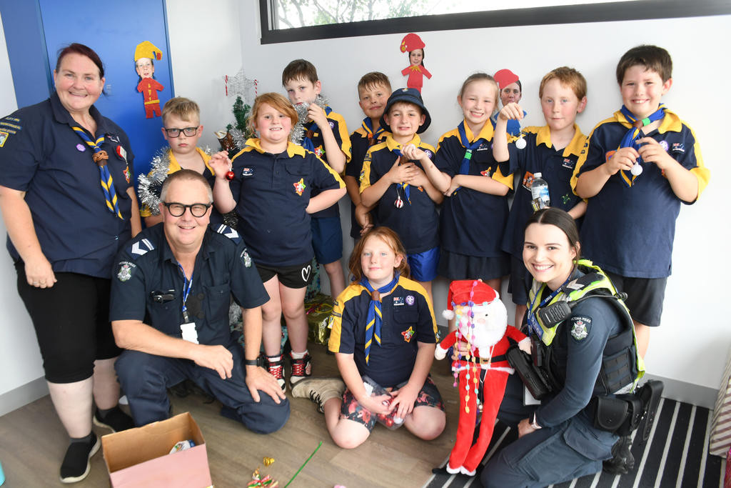 1st Warracknabeal Scout Group cubs bring their Christmas spirit as they decorate Warracknabeal Police Station. Pictured is cub leader Jackie Cooksley "Possum", leading senior constable Shayne Riggall and senior constable Jazmin Zajac with the cubs. Photo: DAVID WARD