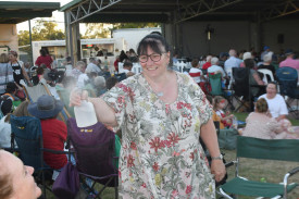 Yarriambiack mayor Cr. Kylie Zanker keeps everyone cool with a fine mist of water spray to keep the heat of Sunday night at bay, while Stacey Drage accepts the welcome squirt.