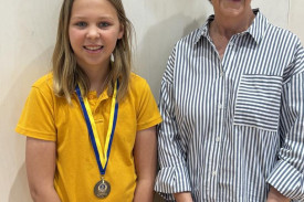 Year four student Savannah B wearing her integrity award medal with Heather Pilgrim.