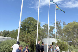 Dimboola Girl Guides and DMSC school captains Liam Campbell and Marcel Badua raise flags during the ceremony.