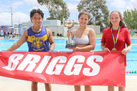 Christian Macalinga, Bailee Norton and Ella Lloyd claim the winning swimming trophy for 2025. Photo: EMILY FRIEDRICHSEN