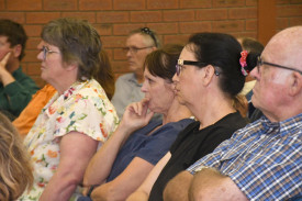 Community members listen intently to what speakers have to say at the meeting.