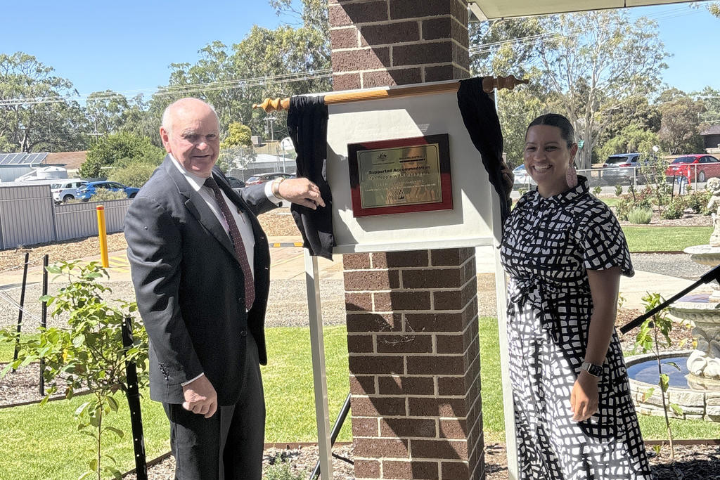 Senator Jana Stewart unveils the official plaque for the residence with Woodbine president Ian Penny. Photos: CAITLIN MENADUE