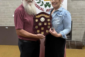 Trish Heinrich is presented with the Ken Smale Award for 2025 by Colin Newell.