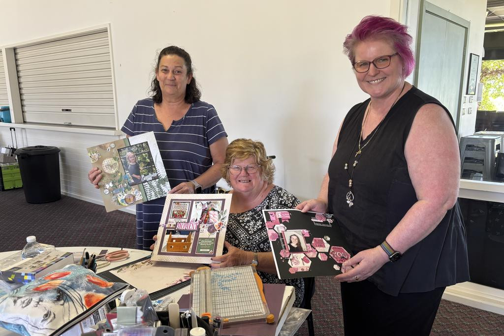 Zoe-Lee Harberger from Dimboola, Desrae Hitchburn from Mildura and Tracey Harrison from Horsham smile on the first day of the scrapbooking retreat last Friday as they show off their work. Photo: CAITLIN MENADUE