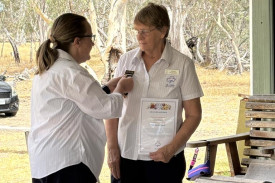 Wimmera Girl Guides district manager Leigh Younger presents Janet Pilmore with the Flowering Gum badge.