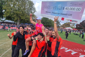 John Evans celebrates his historic Stawell Gift win with his training squad and friends.