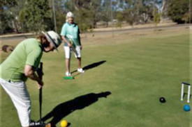 Kelly Walker lines up a shot for the hoop, watched by Christine Hiscock.