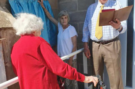 Pastor Eckerhardt Friesen dedicates the plaque with Joy McLean and Dorothy Christian.