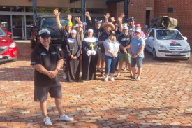 Gavin Morrow with the pit crew and drivers on the Drive to Survive three-day trip to raise money for cancer research