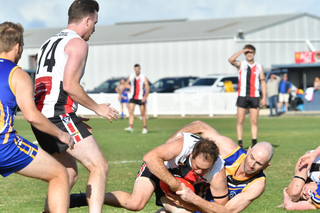 Natimuk's Adam Coutts tackles Edenhope's Boyd Packer.