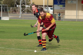 Warrack Hoops’ Aiden Ciemcioch runs with the ball, pursued by Will Gulline of the Horsham Hurricanes.