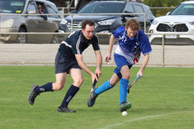 Yanac Tigers Raine Mackley runs with the ball with Kaniva Cobra Noah Krelle looking for an opportunity to spoil.