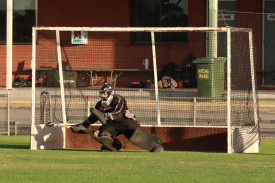Hurricanes’ goalkeeper Lars Simmons successfully defends a penalty stroke.