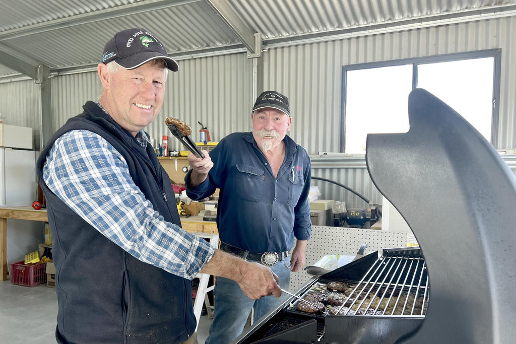 Rainbow Men's Shed team leader Bernard with Mick Hobo cooking sausages for attendees on the open day of the shed last Thursday.