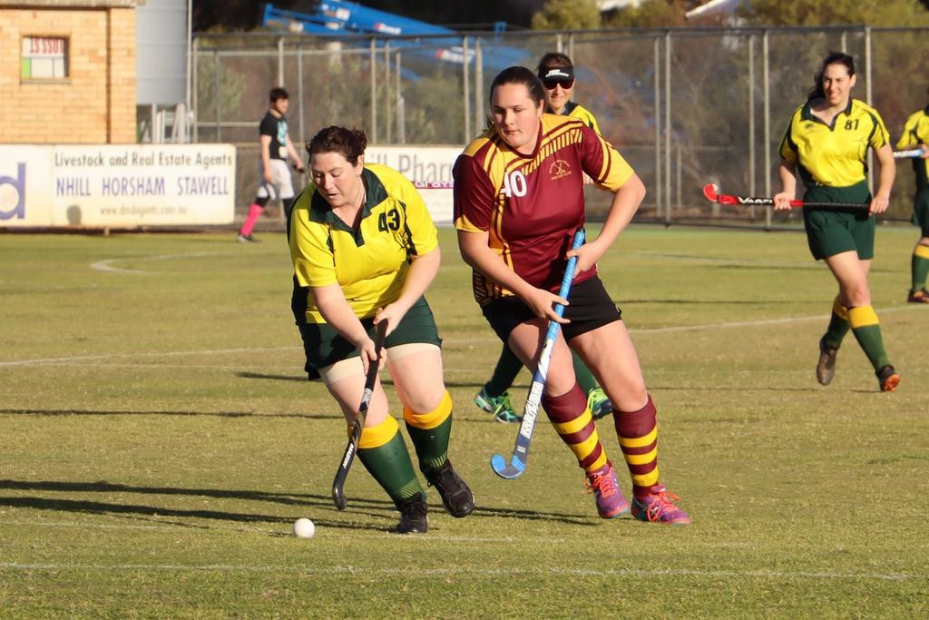 Dimboola’s Naomi Kuhnell runs with the ball with Warrack’s Hailey Bentley in pursuit.