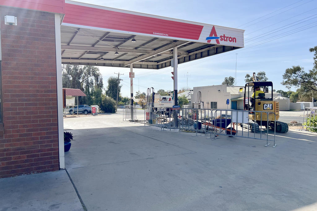 Workers are replacing the old fuel pumps with the latest ones.