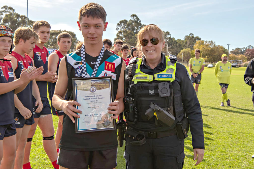 Spirit of Football award winner Jules Lockwood accepts his award from Senior Constable Marie Doolan.