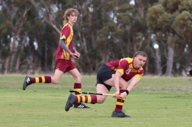 Warrack Hoops’ defender Hamish Wagenknecht clears the ball out of defence with teammate Ben Williamson in support.