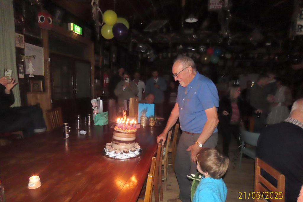 Danny prepares to cut the birthday cake.