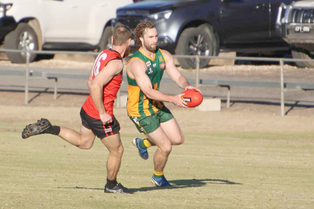 Dylan Landt looks to kick the ball to the advantage of Dimboola.
