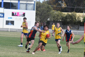 A Horsham College student tries to evade an Ararat defender.