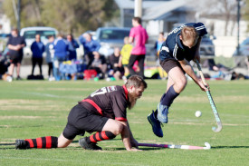 Yanac Tiger Todd Alexander jinks the ball and leaps over a desperate blocking attempt by Horsham’s Aaron Mullane.