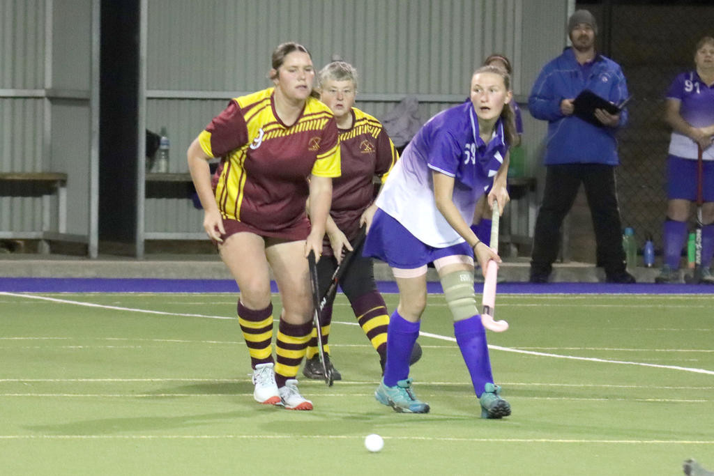 With her coach, Clint Beattie, looking on in the background, Kaniva’s Briony Williams looks for options as Warrack’s Madisson Bentley and Debbie King look to tackle.