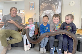 Bronte, Ivan, Dawson and Isi are all smiles while holding Ave the Olive Python.