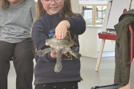 Rahli holding Tommy the Long Necked Turtle.