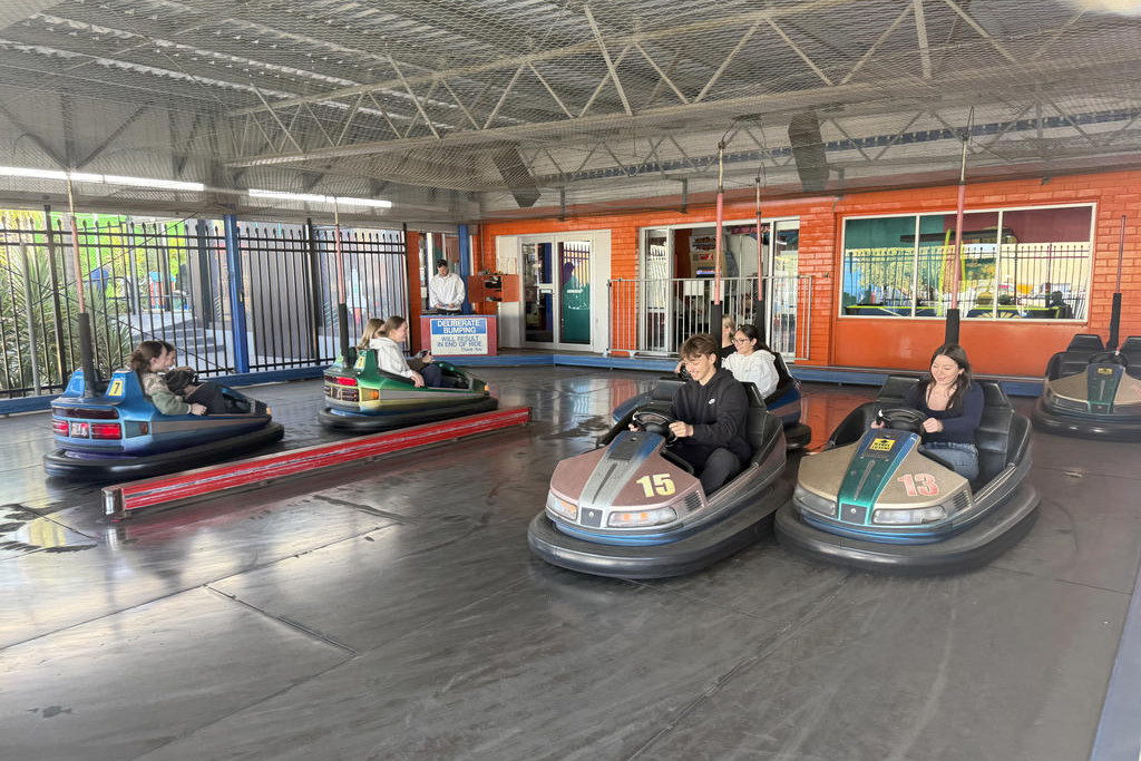 Year 12 students riding bumping cars during their trip to Mildura.