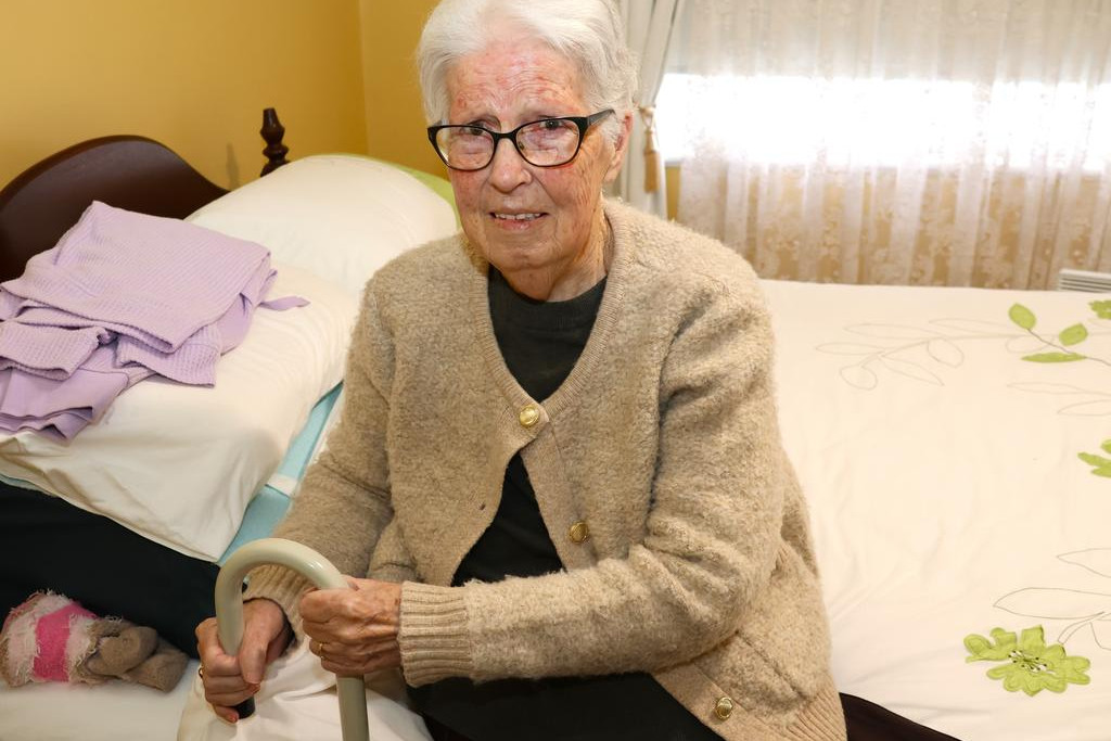 Betty Etherton uses the bed stick attached to her bed to make getting up much easier.