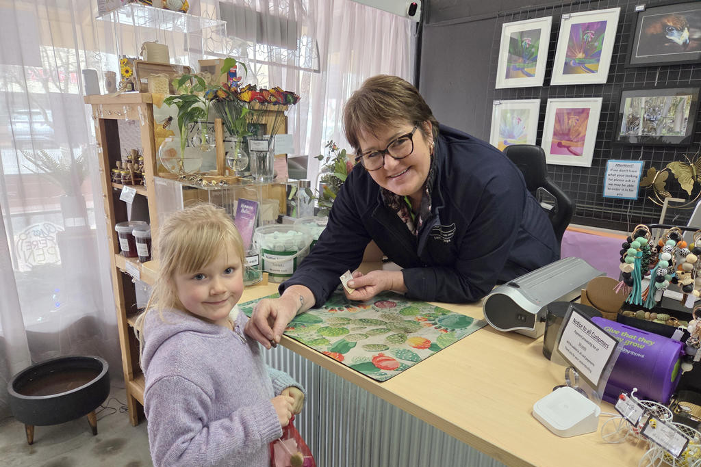 Harper Rethus, 5, from Yea collects her gemstone from Michelle Danisch at Desert Blooms Nursery.