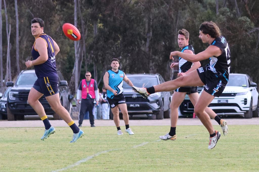 Patrick Grace-Long kicks the ball forward.
