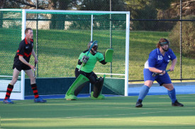 Cobras’ goalkeeper Thomas Ady and defender Logan Krelle brace for a Hurricanes’ shot at goal during a penalty corner, with Will Gulline ready to pounce.