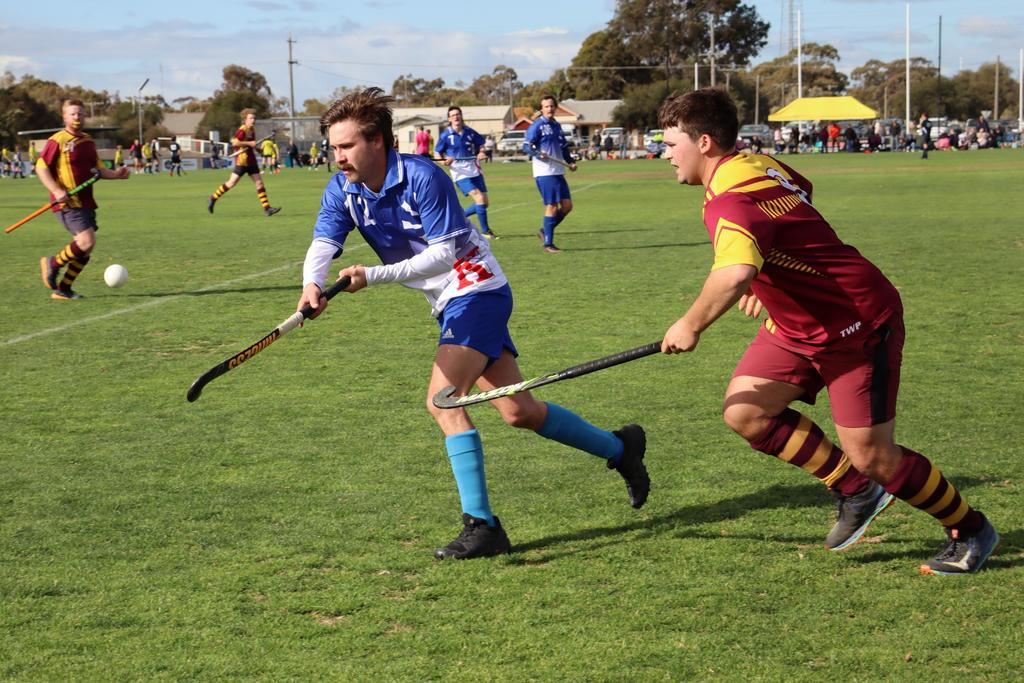 Kaniva’s Lachie Mills plays to control the ball in the air while being pursued by Warrack Hoops’ Oskar Bennett.