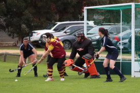Warrack’s Maryann Paris shapes to clear the ball during a penalty corner ahead of goalkeeper Mel Bentley, with Yanac attackers Susan Hedt and Alexis Farmers waiting to pounce.