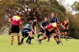 Hoops’ Mark Peters bursts out of a pack with the ball.