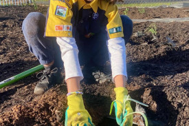 Evie is all smiles while planting.