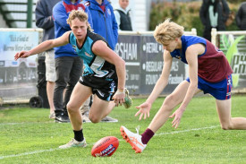 Fletcher Keller has eyes only for the footy.