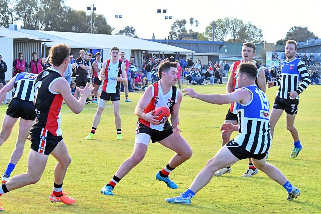 Horsham Saints player Mitch Martin sells the dummy, putting Brylie Cameron on the back foot.
